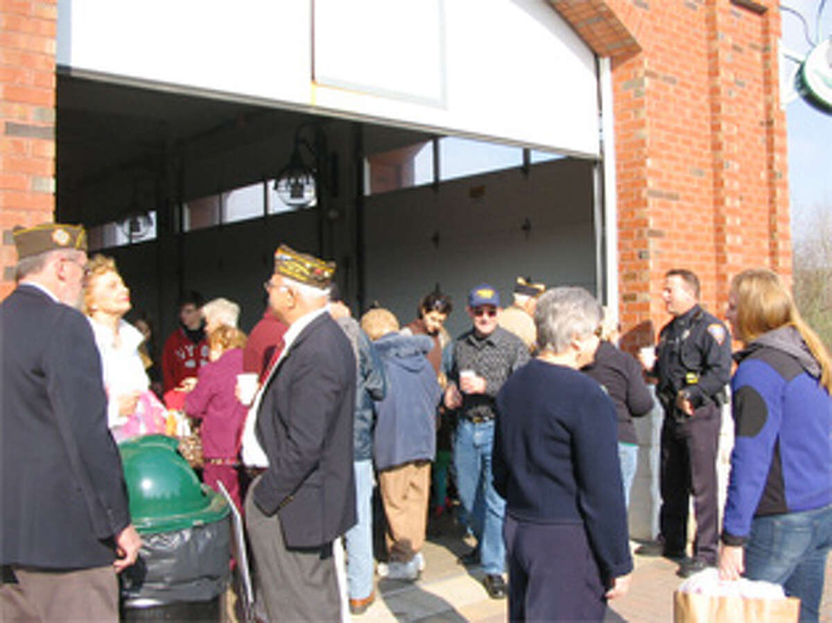 A view of last year’s post-ceremony doughnuts-and-coffee event at the Shelton Farmers Market Building.
