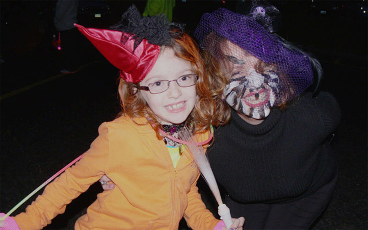 Bailey Pierce, 7, left, as a devo witch and her mom Brenda as a scary spider at the 2013 Trick or Trunk event in Shelton.