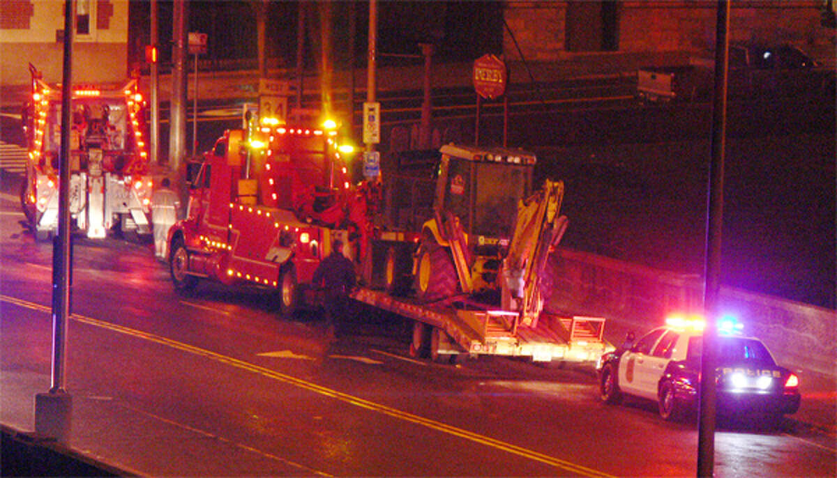Two tow trucks on the Derby/Shelton Bridge as preparations are made to tow away the trailer with the piece of construction equipment. The truck carrying the trailer had already been removed from the scene.