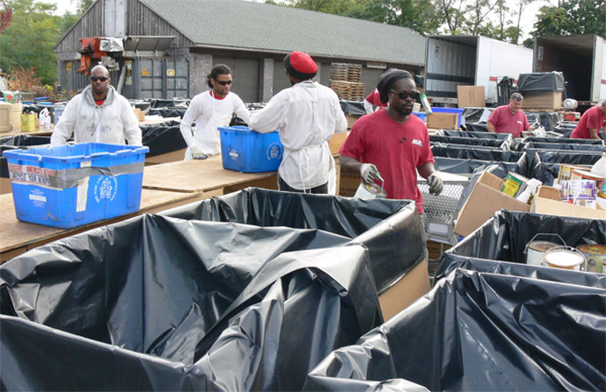 Workers from MXI Environmental Services sort collected items during Shelton's Household Hazardous Waste Collection Day.