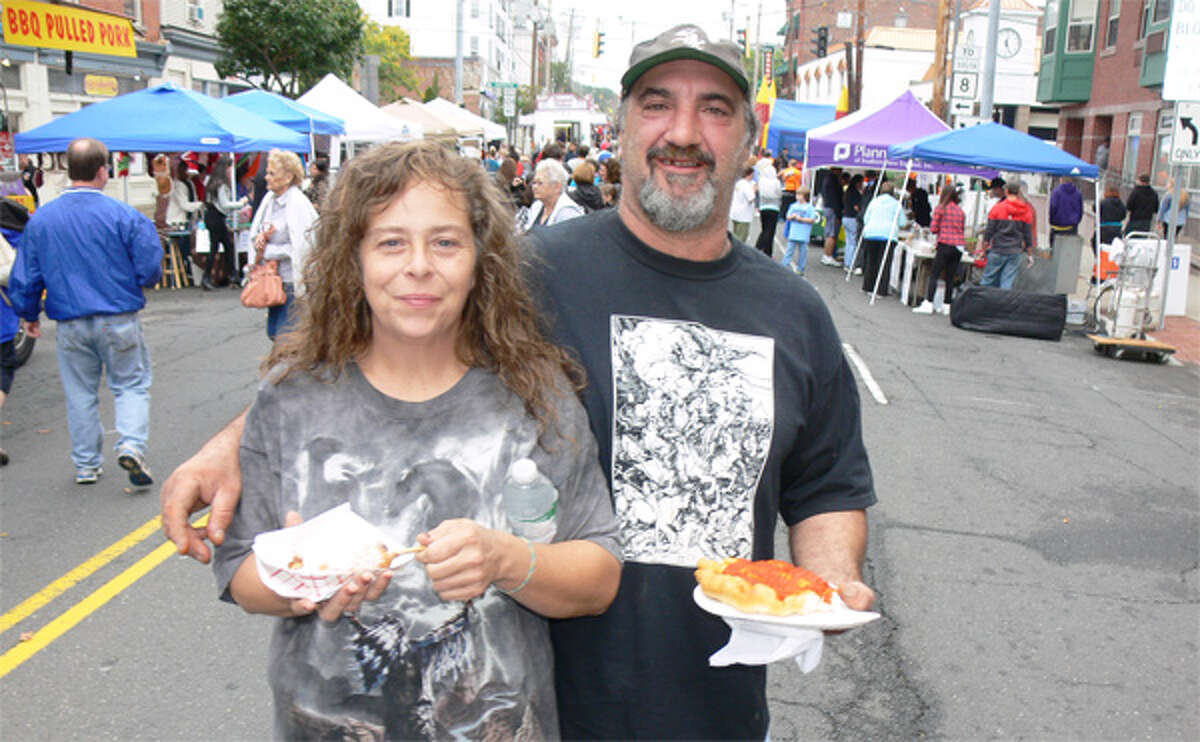 Sheryl and Steve Gabriel enjoy carnival food while standing on Howe Avenue during the Shelton Day celebration.