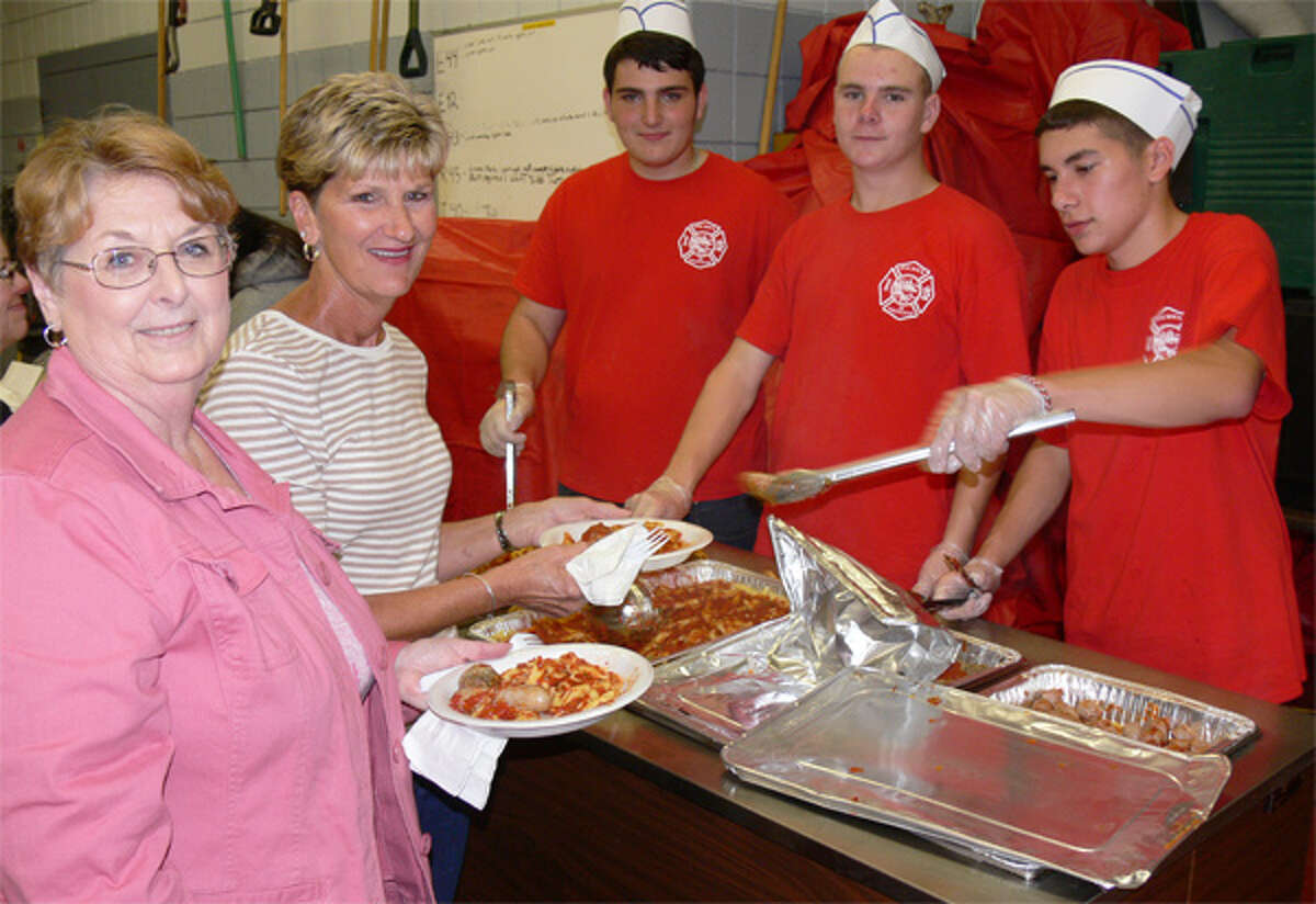 From left at the 2013 ziti dinner, Paula Honcz and Nancy Barhick, both of Milford, are served by Pine Rock Park Fire Company members Joe Watton, Ryan Sileo and Kyle Kosiorowski.