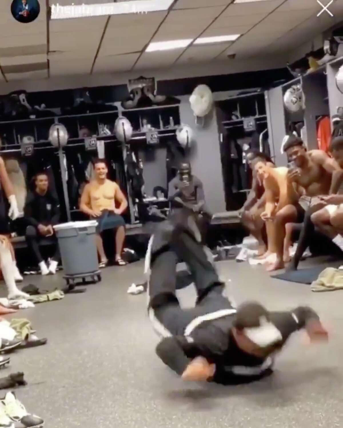 A man, identified by Bleacher Report as a Raiders janitor, busts a move in the team locker room.