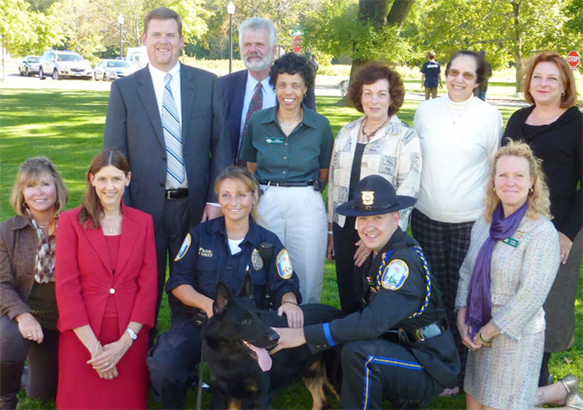 Shown from left, bottom: Trap Falls Kennel Club (TFKC) member Cindy Sherman, American Kennel Club (AKC) Communications Director Lisa Peterson, Newtown police officer and K-9 handler Felicia Figol, K-9 dog “Saint,” Newtown police officer Matt Hayes, TFKC President Laura Wells; and top: TFKC member Chris Sweetwood, AKC Reunite CEO Tom Sharp, and TFKC members Cindy Richardson, Lauren Friedman, Jan Miller and Sarah Murphy.