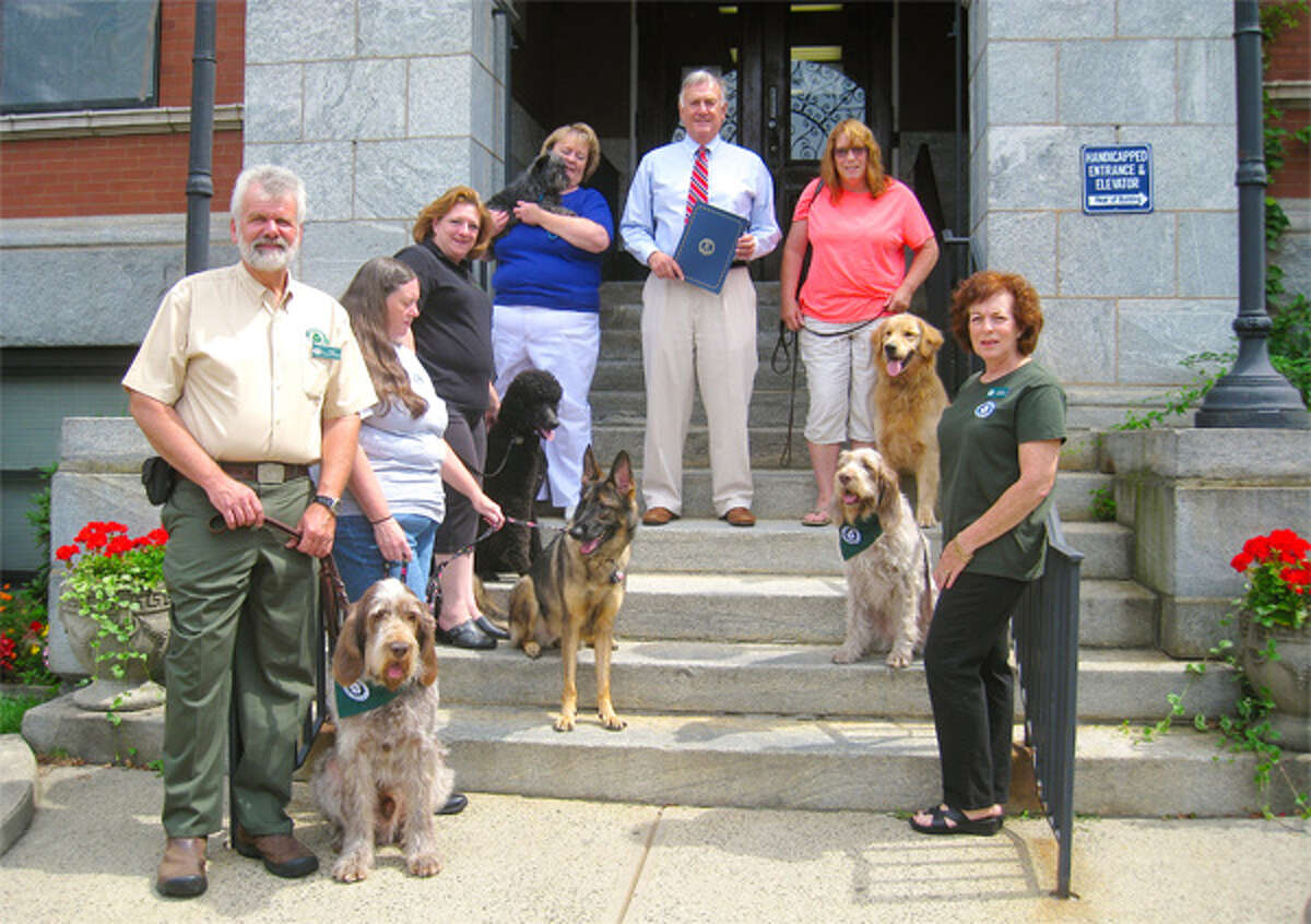Trap Falls Kennel Club members, with their dogs, on the steps of Ansonia city offices, are Christopher Sweetwood, Eva Skrabl, Sarah Murphy, Susan Carter, Ansonia Mayor James Della Volpe, Karen Batistelli of Shelton, and Lauren Friedman.
