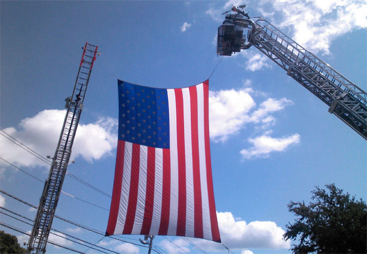 A large American flag is displayed for motorcyclists participating in the annual tribute to 9/11.