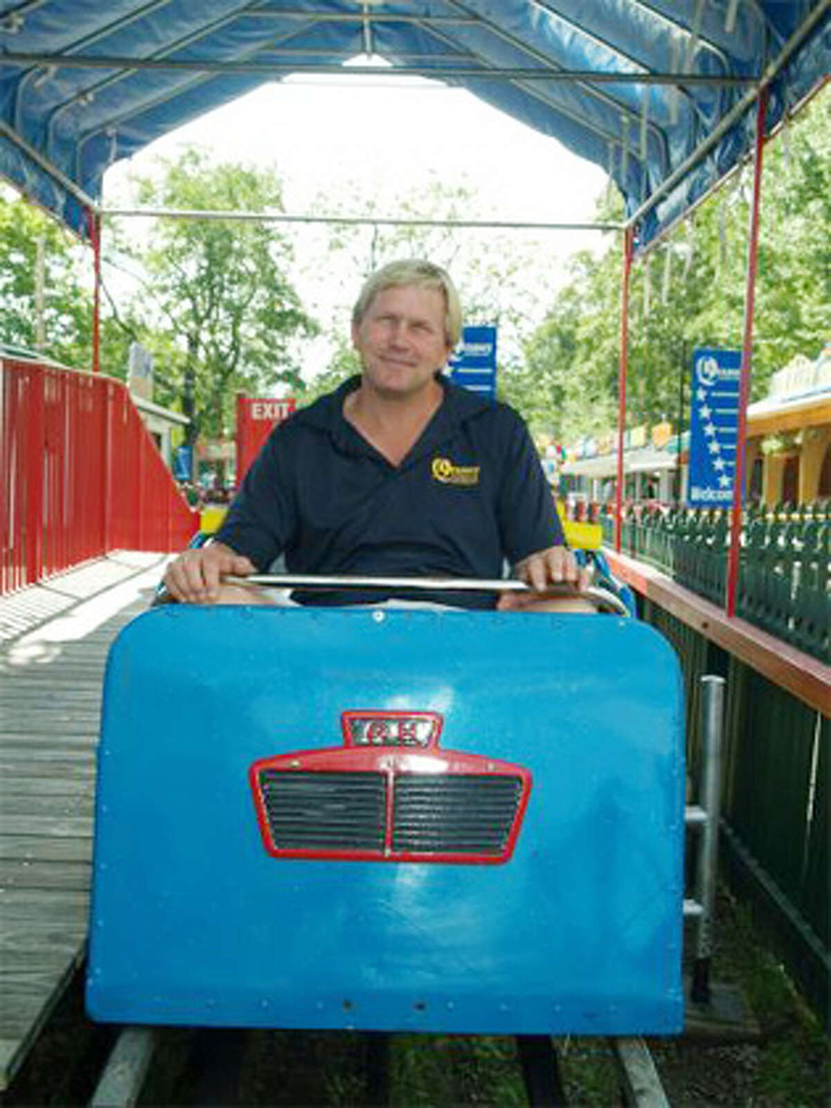 Quassy Amusement Park President Eric Anderson sits in the front seat of the classic Allan Herschell Little Dipper roller coaster at the Middlebury park. (Quassy-provided photo by Ron Gustafson)