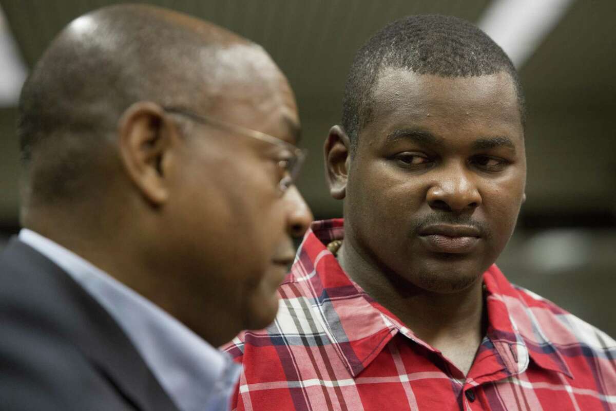Alfred Dewayne Brown, right, 33, listens to state Sen. Rodney Ellis talk about the request to compensate Brown with state funds for his wrongful conviction. Brown's attorneys are seeking almost $1 million, as well as health-care and tuition dollars for his daughter's education. Brown was convicted of capital murder and sentenced to death in October 2005. After 12 years imprisoned, his conviction was overturned after the discovery of evidence substantiating his alibi. Monday, Feb. 22, 2016, in Houston.