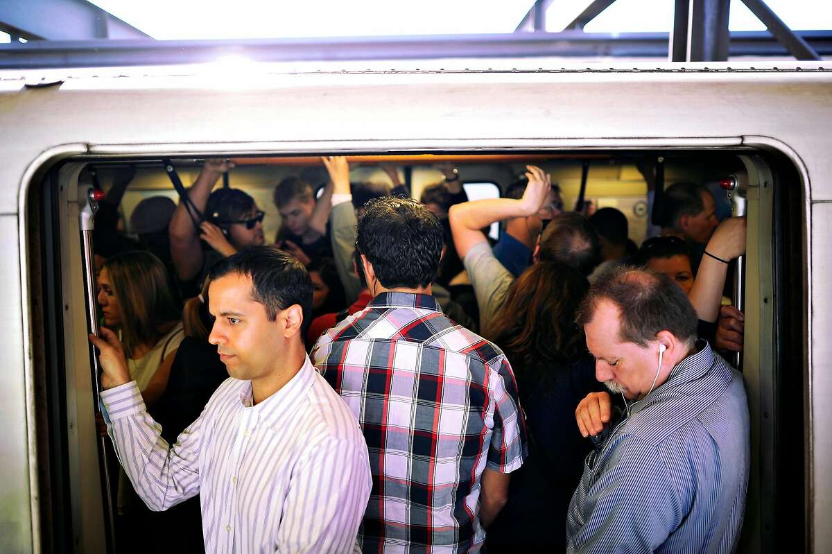 Crowds of commuters are seen tightly packed aboard a San Francisco bound train as it wait to leave the MacArthur BART station in Oakland, CA on Friday May 31st, 2013. BART is experiencing severe delays while trains are running single track after two maintenance vehicles collided in the transbay tube, resulting in track damage needing repair.