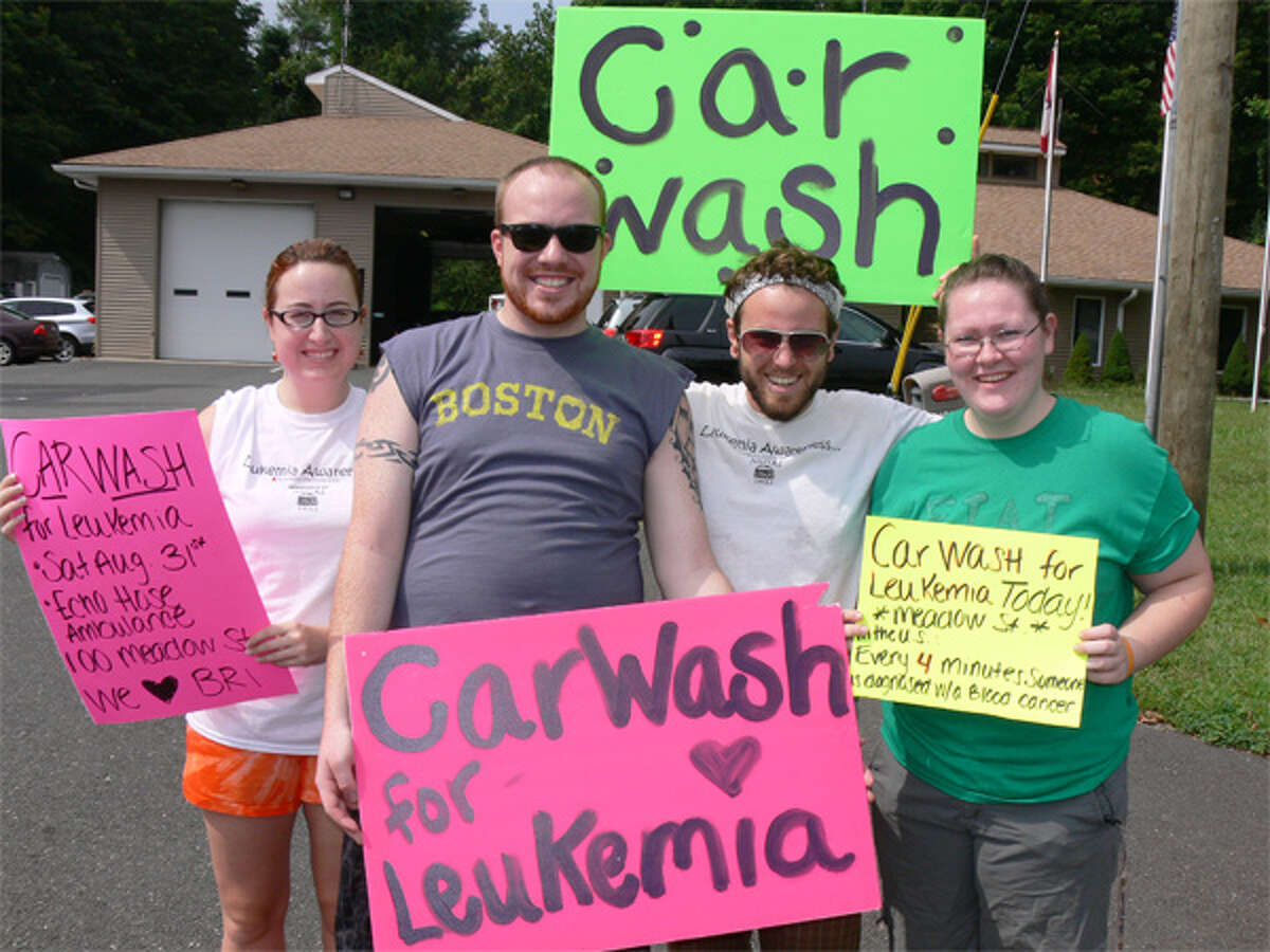 From left, Kaitlin Kelley of Shelton (SHS ’06), Geoffrey Carr of Orange, Dan Carr of Milford (Katie Thompson’s fiancé) and Kristen Kingsley of Shelton promote the car wash while standing near Meadow Street, in front of EMS headquarters.
