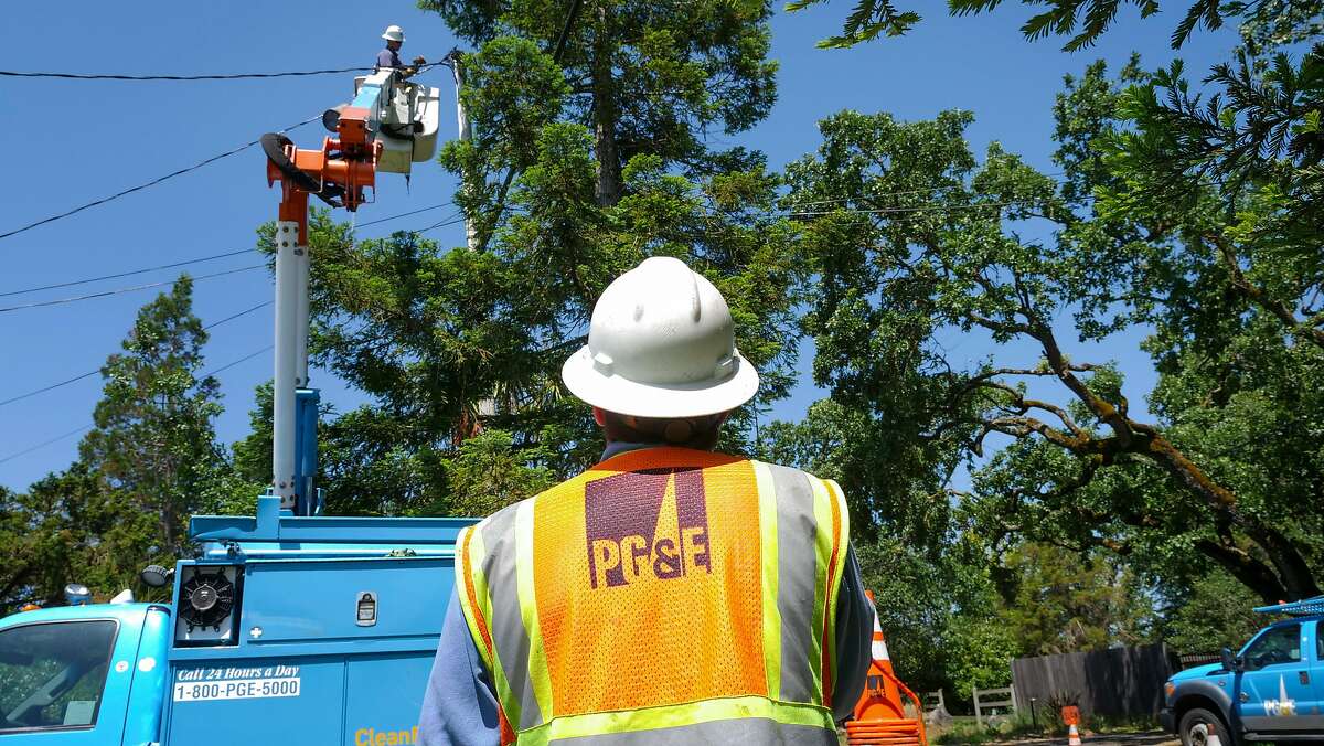 Matt Edgar an appentice lineman with PG&E helps out AJ Jensen as he does routine repairs along Hall Road, Wednesday May 29, in Santa Rosa, CA.