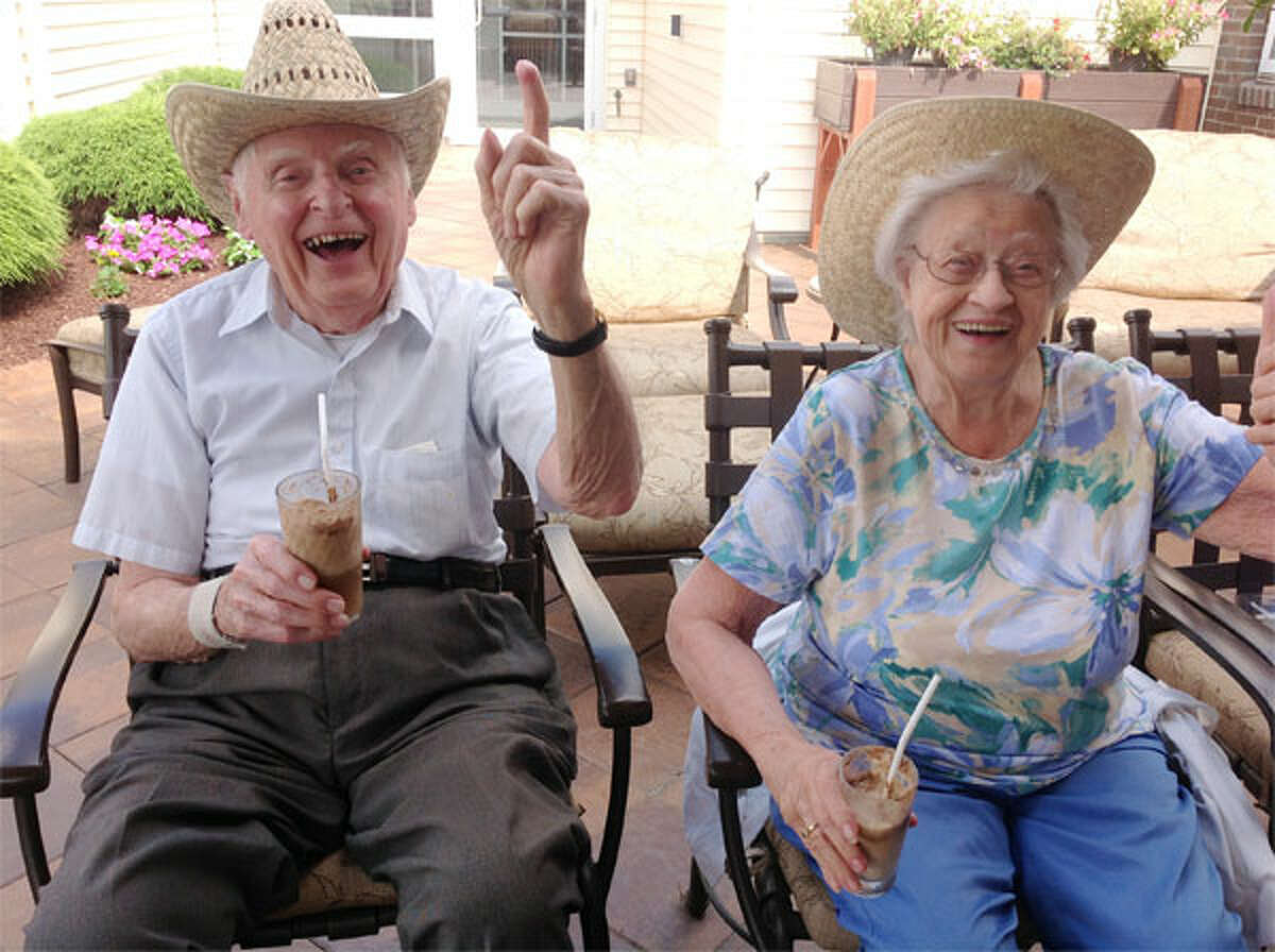 Crosby Commons residents Hank Gambaccini and Corrine Sharp drink sarsaparilla floats for Country Western Day.