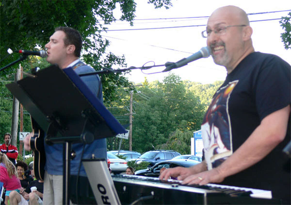 Members of Fools on the Hill, a Beatles tribute band, entertain the crowd at the Aug. 14 show.