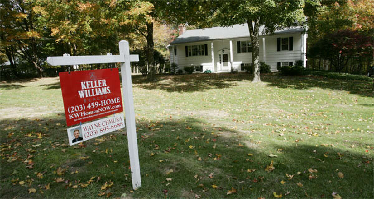 A house with a For Sale sign in the region. (File photo)