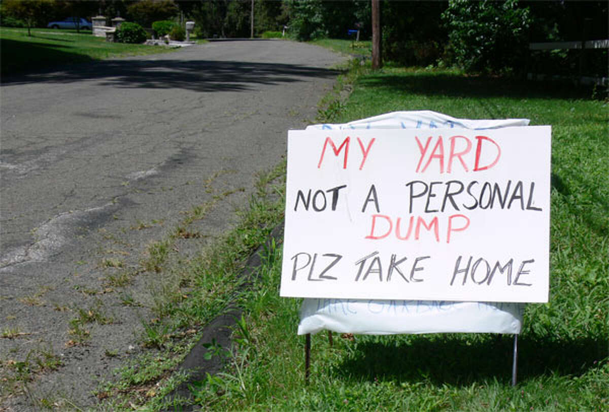 A Shelton homeowner created this sign to try to stop a passing motorist from throwing garbage on her property.
