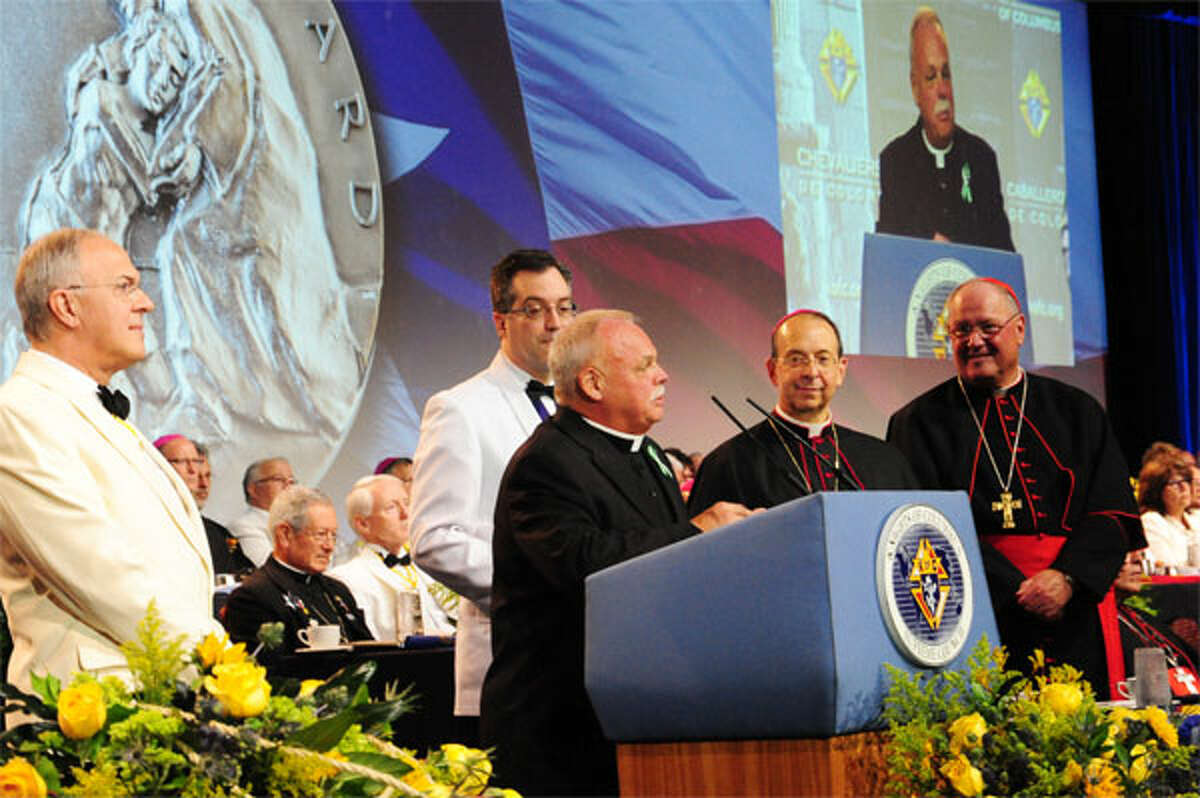 Monsignor Robert Weiss, and Grand Knight Timothy Haas of Newtown, accept the inaugural Caritas Awards for exemplary works of charity at the 131st Knights of Columbus convention in Texas. Weiss previously was pastor of St. Joseph Church in Shelton.