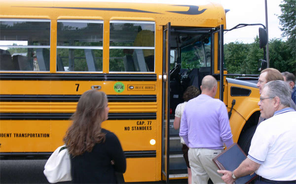 Educators, school board members and others check out the new propane-fueled bus.