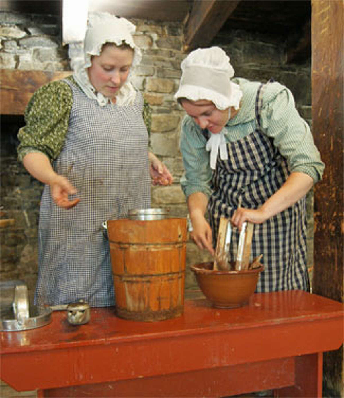 Women at Old Sturbridge Village making ice cream with the hand-cranking method, as was done in the 1830s.