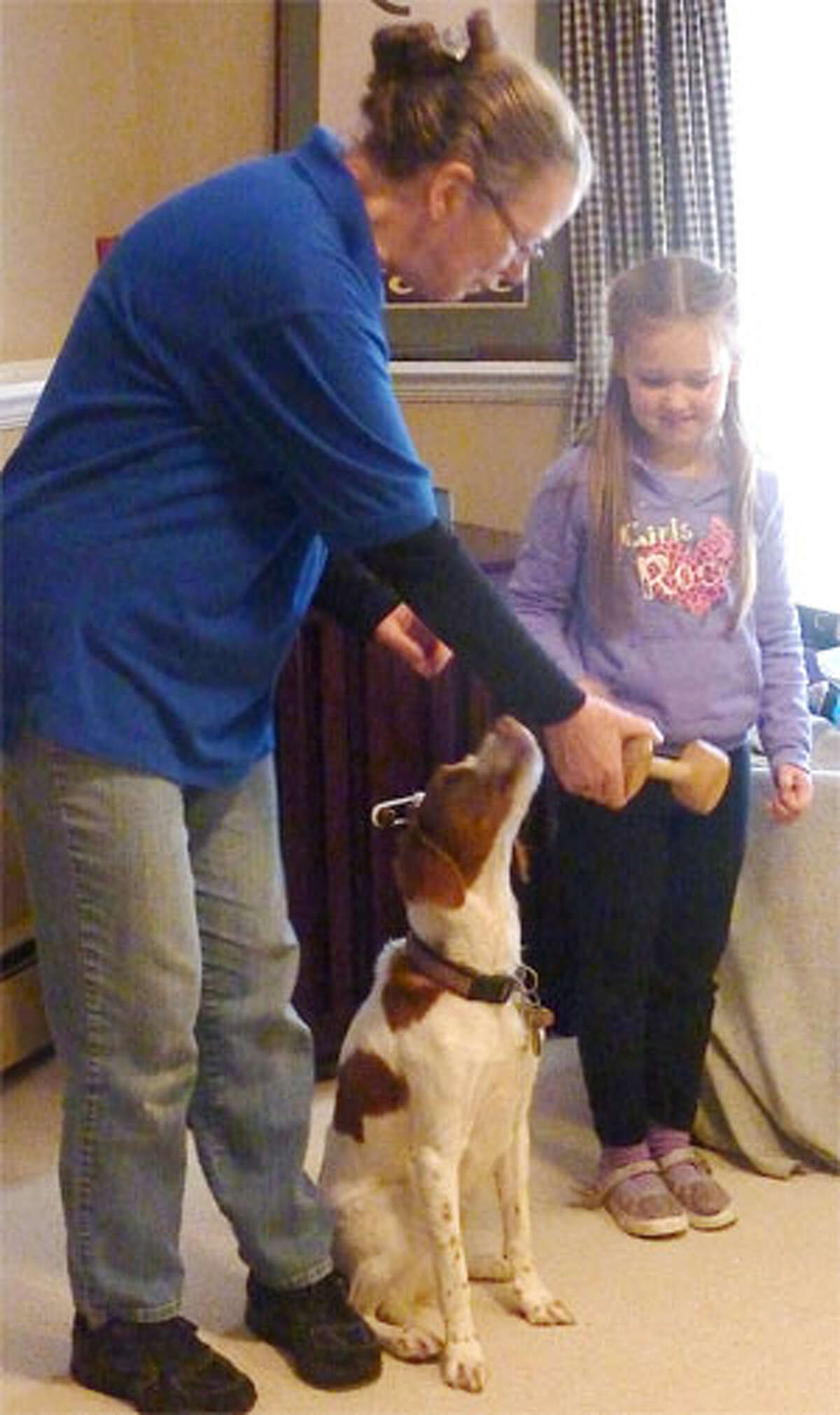 Dona Campbell with a young helper at a Trap Falls Kennel Club's Doggie Safety Education Program for a Weston Brownie troop.