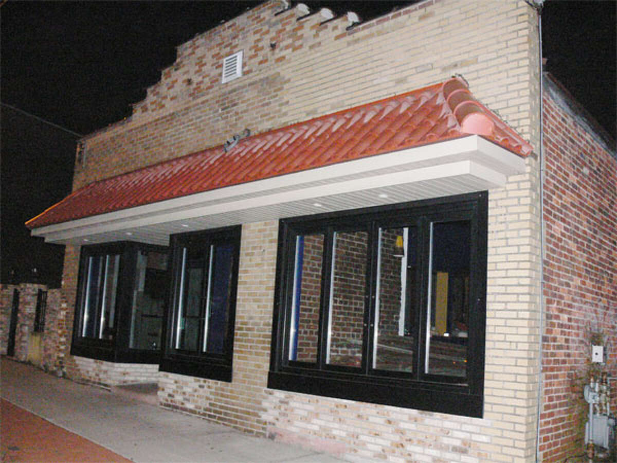 The outside of Caliente Bar & Grill in downtown Shelton on Monday night, with the establishment’s logo sign gone and the doors closed.