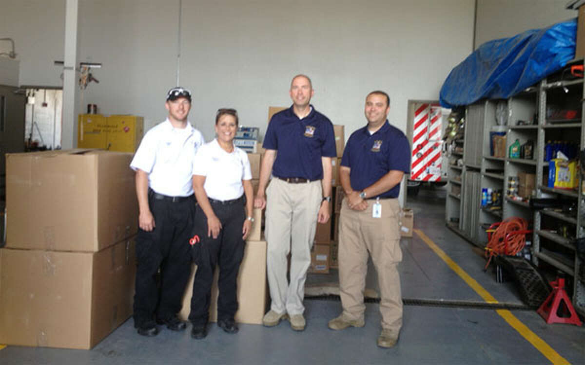 On the right, Shelton Echo Hose Ambulance volunteers Tim Greer and Jeff Caporaso with Oklahoma EMS personnel and post-tornado supplies at the Sugar Creek EMS in Oklahoma. (Photo provided by Twitter@EMT_IN_CT)