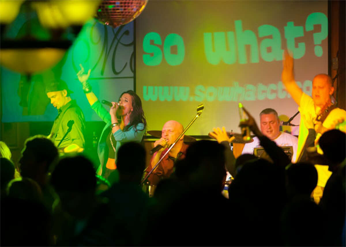 Members of the band So What? perform at a show — from left, Greg Blasko on guitar, Melissa Sgambelluri on vocals, Dave Legeret on vocals and guitar, Dan Marcil on drums, and Jason Mendelsohn on bass.