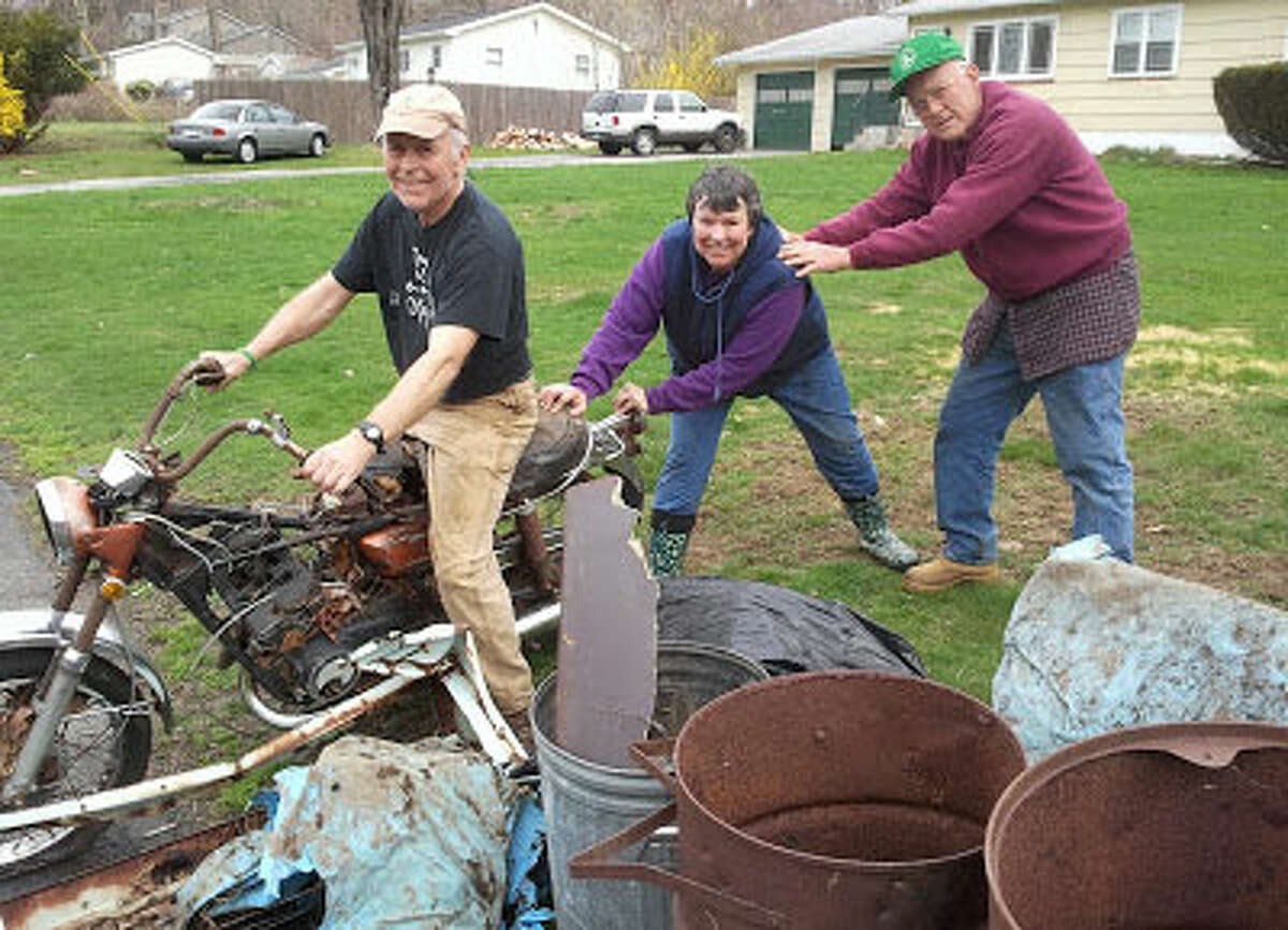 Shelton Land Trust members with an old motorcycle pulled from the woods during the Clean Sweep.