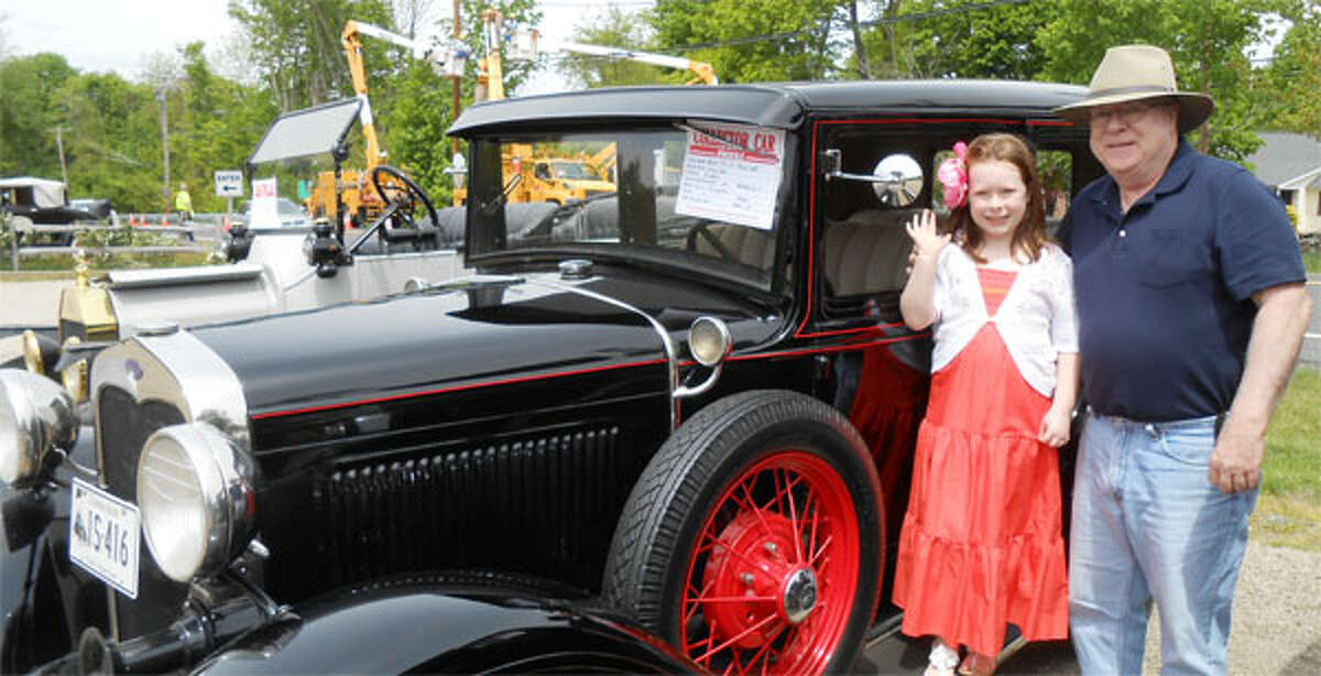 Bill Mohyde, of Shelton, with his granddaughter Molly Mohyde, 7, in front of his 1930 Model A, four-door Town Sedan at the third annual Old Car Meet in 2013 at Beardsley’s Cider Mill in Shelton. (Photo by Karen Kovacs Dydzuhn)