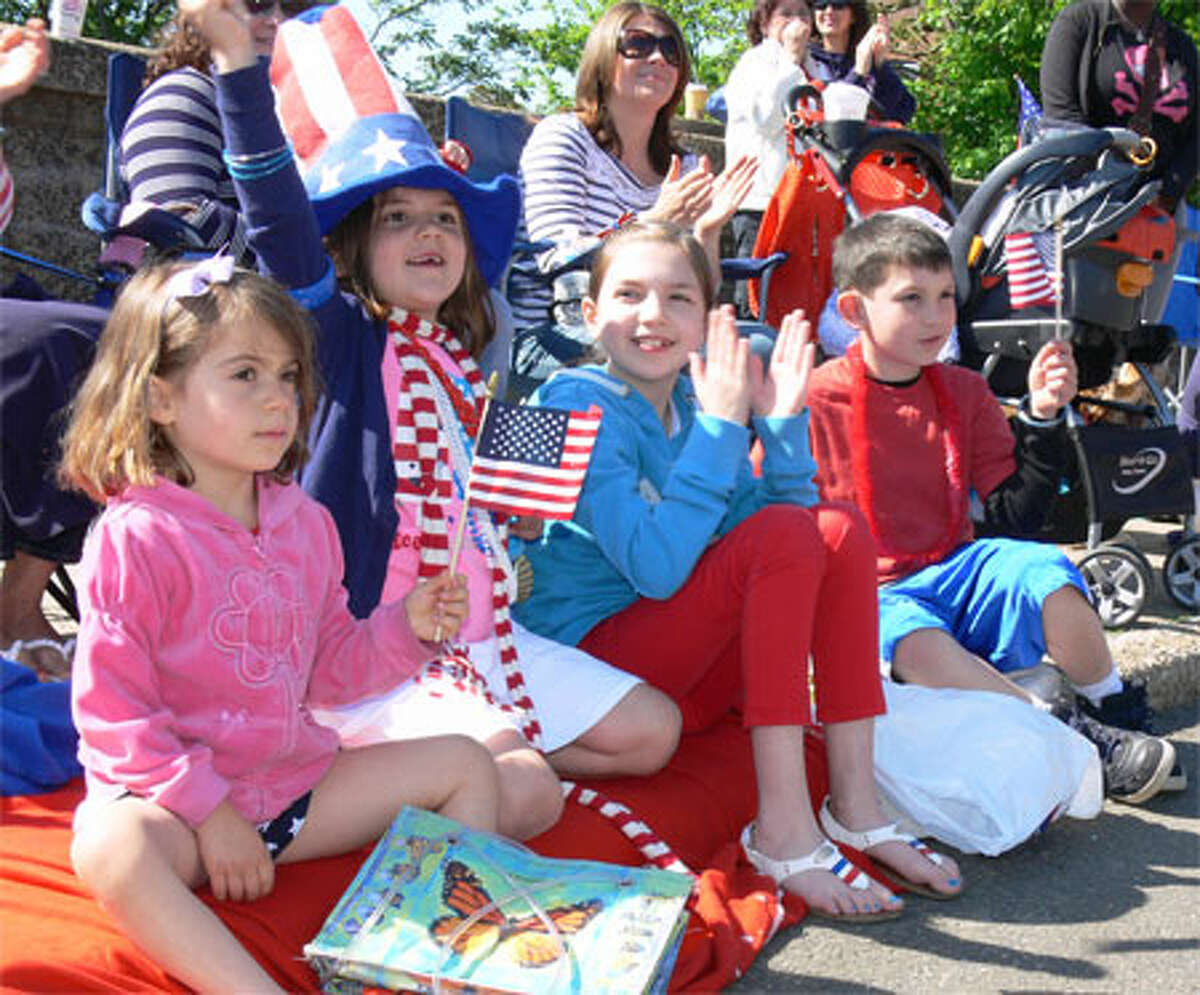 Cheering the marchers on the parade are Shelton youngsters, from left, Lia Monteiro, 4; Ella Welsh, 6; Cora Welsh, 11; and Ryan Welsh, 7.