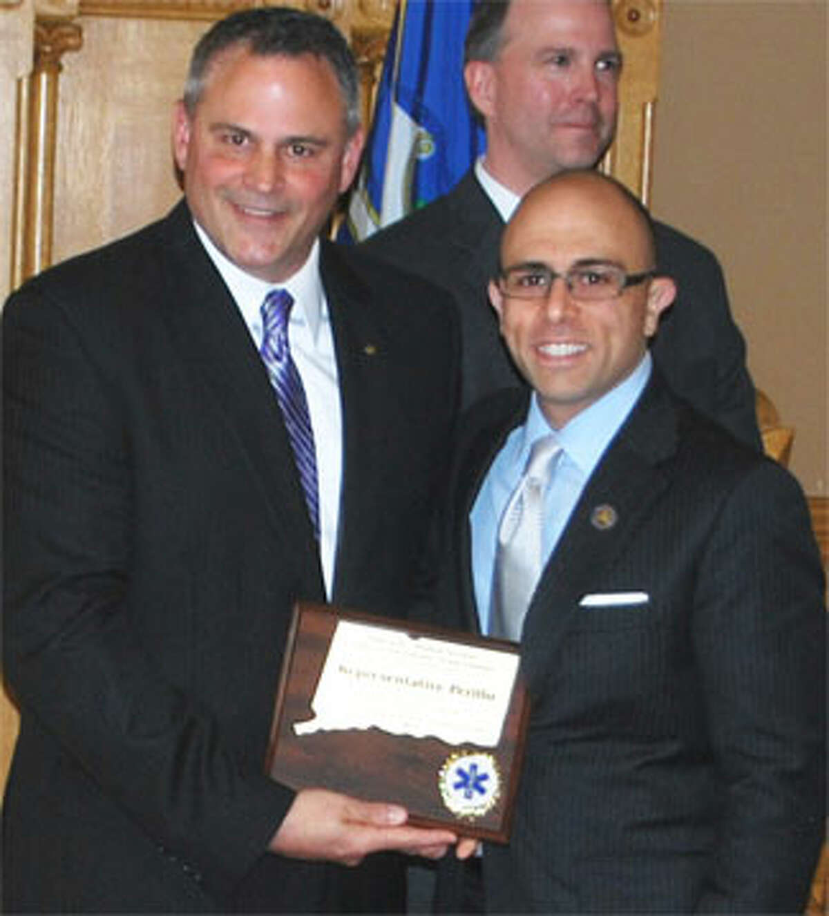 State Rep. Jason Perillo of Shelton, right, receives the legislator of the Year Award from Greg Allard, president of the Council of Regional Chairpersons of the Connecticut EMS Councils.