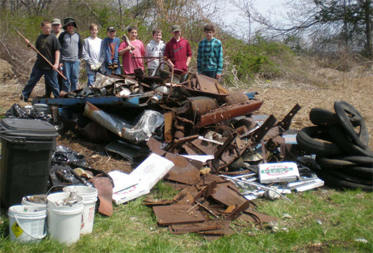 Shown standing behind collected debris are Shelton Boy Scouts Kevin Demaine, Ian Tyler, Kyle Young, Matthew Balcerzak, Isaac Seyer, Zachary McEwen, Brendon Stuart, Charlie Chagnon and Robbie Delgado. Missing from photo is Charlie O’Brien.