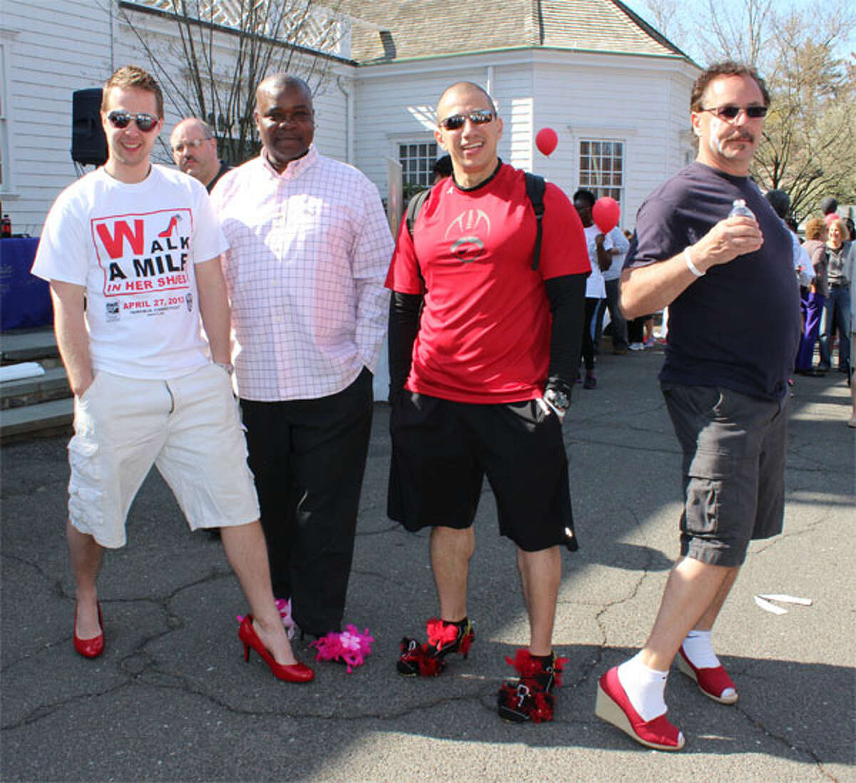 Among those donning feminine footwear for Walk a Mile in Her Shoes on April 27 in Fairfield are, from left, Daniel Chizmadia of Shelton, from Leadership Greater Bridgeport; Martin Goodrich of Bridgeport, Raul Barada of Bridgeport, both from St. Vincent’s Special Needs; and Bill Truini of Monroe, from the Stepney Fire Department. (Photo by John Kovach)