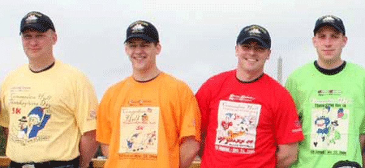 A close-up view of some of the U.S.S. Constitution crew members with their race T-shirts.