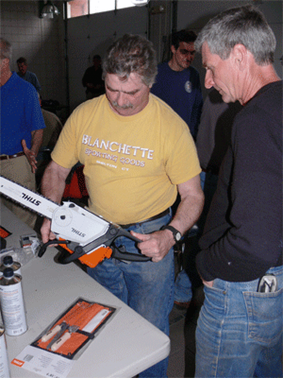 Art Botsford, left, checks out a chainsaw with Joe Puopolo during a break in the session. Botsford and Puopolo both work for the Shelton Parks and Recreation Department.