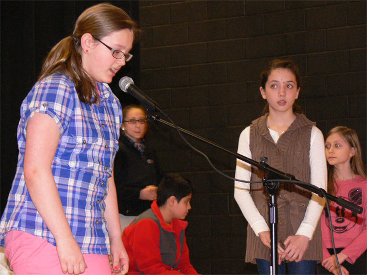 Kelsey Radzion, left, spells a word during the Perry Hill School spelling bee.