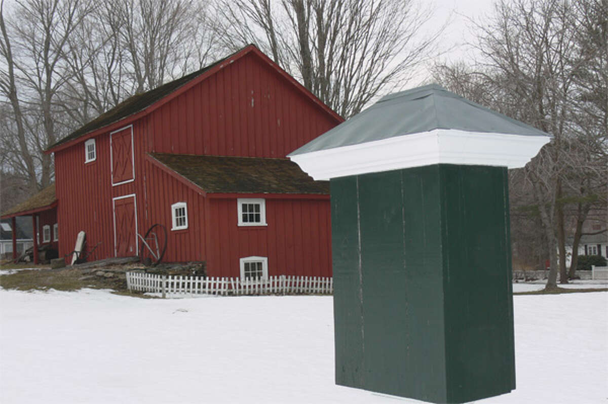 A refurbished sign post, where flyers (or hand bills) would be posted in the old days, is one of the artifacts from yesteryear on the Shelton History Center property. In the background is the Wilson barn from the early 1860s.