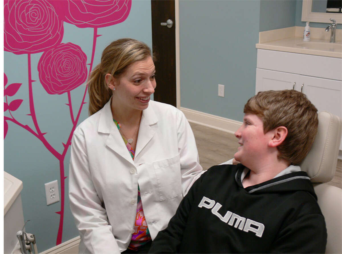 Dr. Maria Karayiannis, an orthodontist, with 14-year-old patient Nik Fritea at her new Shelton office.