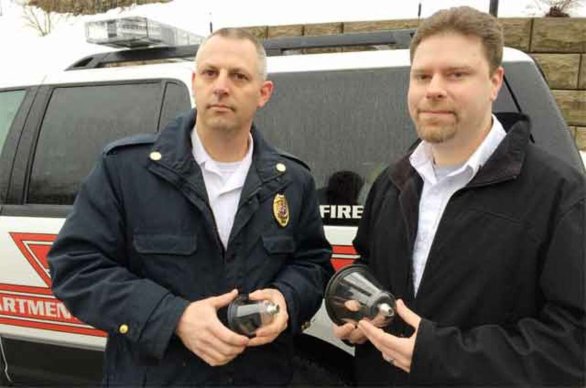 Shelton Fire Chief Fran Jones, left, and Echo Hose Ambulance Lt. Jason Correia, with two of the special oxygen masks for pets donated by the VCA Shoreline Veterinary Emergency Center in Shelton.