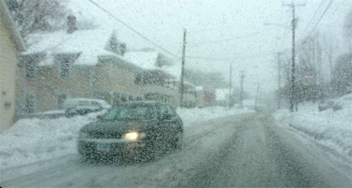 Snow falls on Bridgeport Avenue, near downtown Shelton, during a past storm.