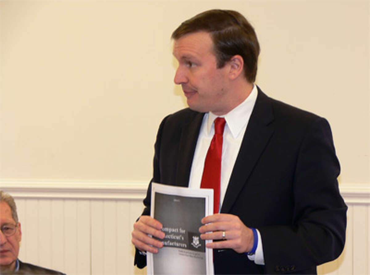 U.S. Sen. Chris Murphy holds a draft of his Compact for Connecticut’s Manufacturing plan that he is working to finalize.