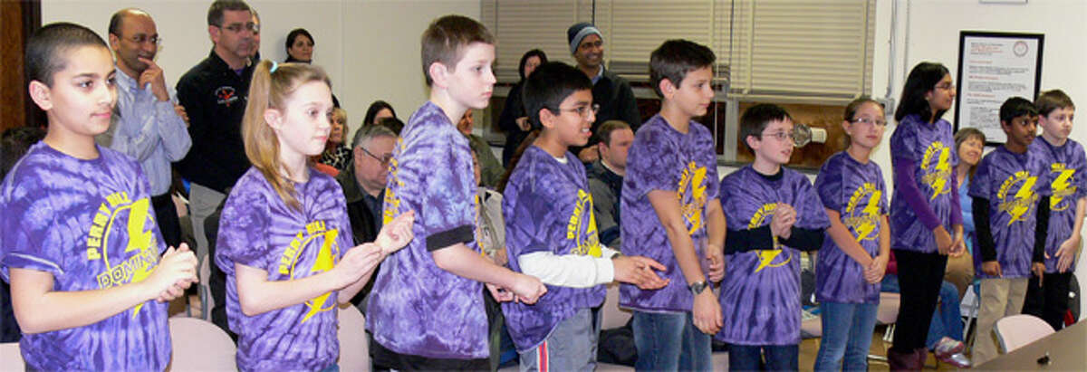 Members of the Perry Hill Dominators stand up to be congratulated by the Shelton Board of Education for winning a state robotics championship.