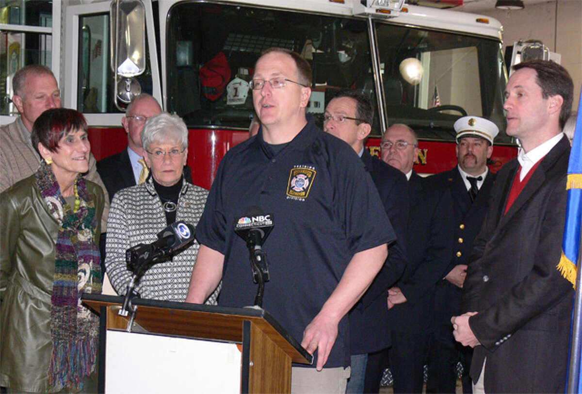 Echo Hose firefighter Kevin Lantowsky, center, speaks at a press event on fire disaster relief Saturday in Shelton while surrounded by public officials such as Mayor Mark Lauretti, U.S. Rep. Rosa DeLauro, Lt. Gov. Nancy Wyman, Gov. Dannel P. Malloy and U.S. Rep. Jim Himes.