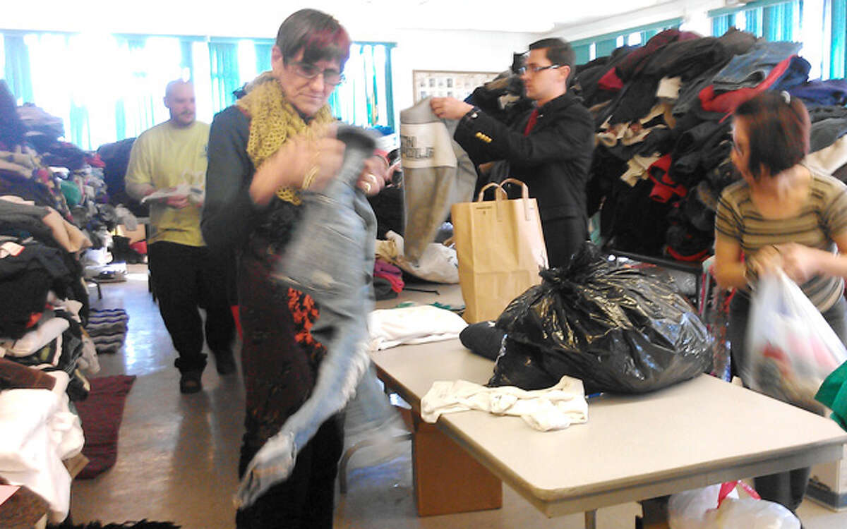U.S. Rep. Rosa DeLauro joins others to help sort clothing items donated for fire victims on Tuesday morning at the Echo Hose firehouse. (Photo by Robin Walluck)