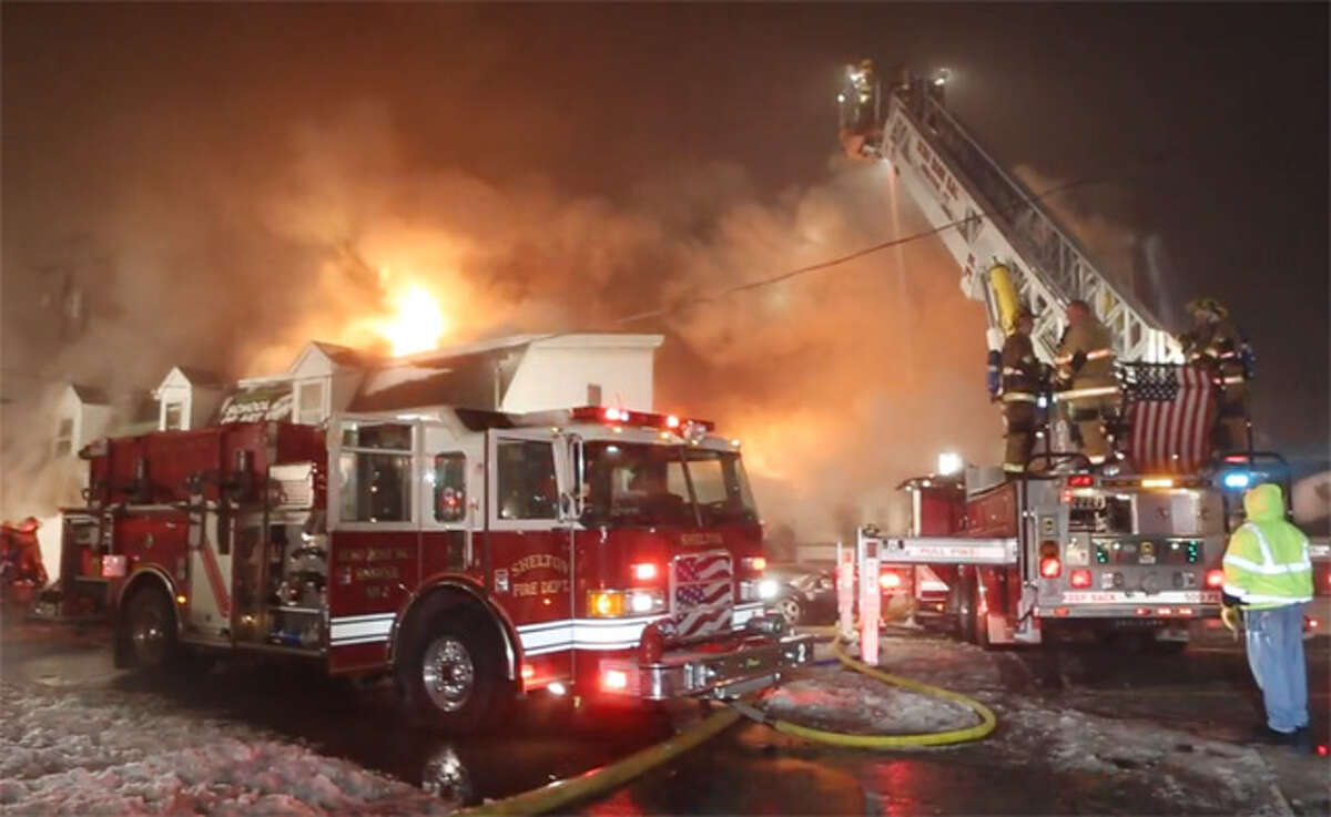 Shelton firefighters battle the late-night fire on Howe Avenue in January 2014.