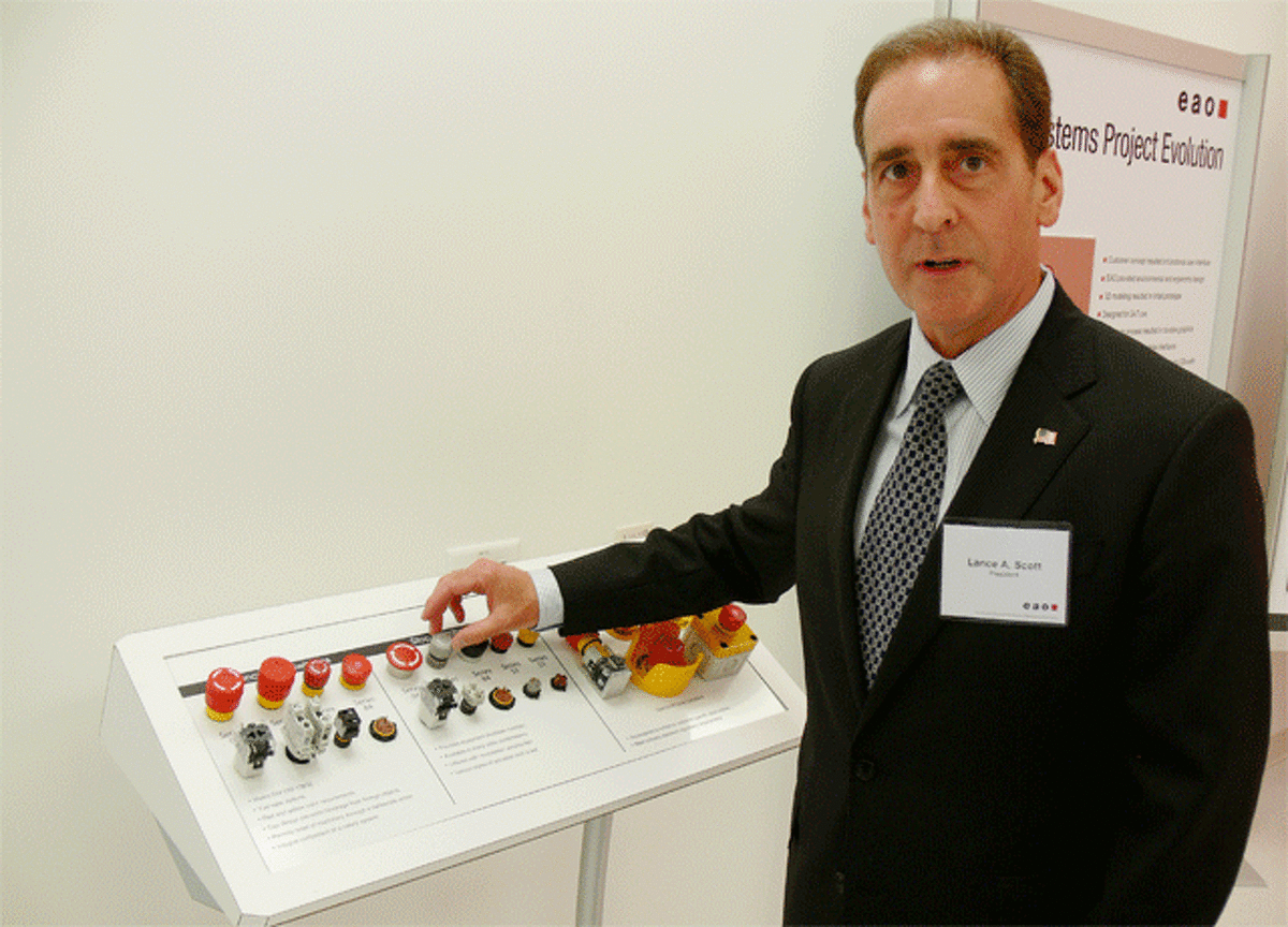 Lance Scott, EAO president, with a control device on display the company’s new North American headquarters in Shelton.