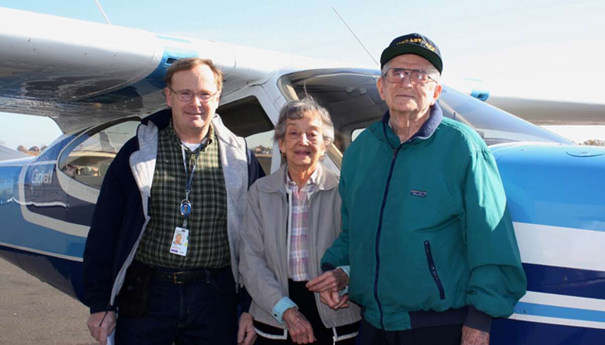 From left, pilot George Clark with Crosby Commons residents Helen Carlson and Bob Shields.