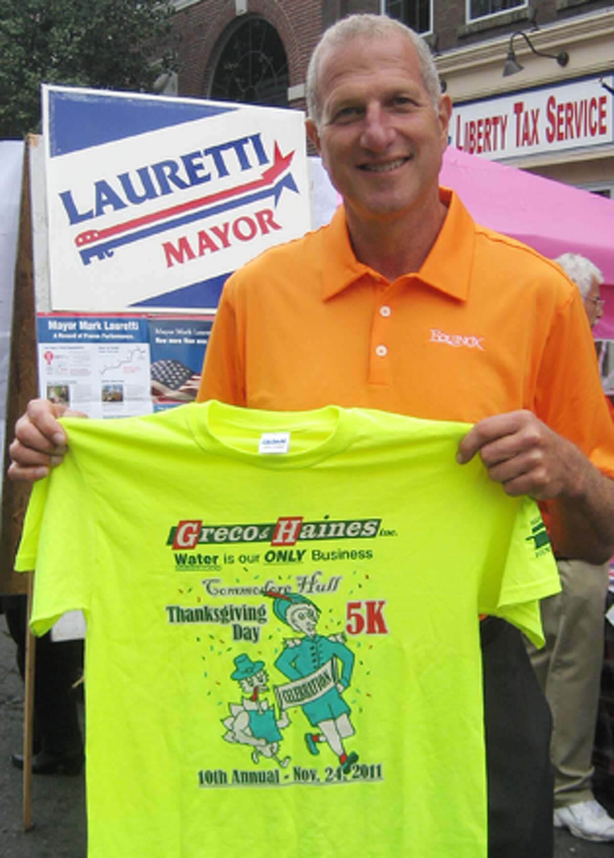Mayor Mark Lauretti with a Commodore Hull Thanksgiving Day 5K Road Race T-shirt.
