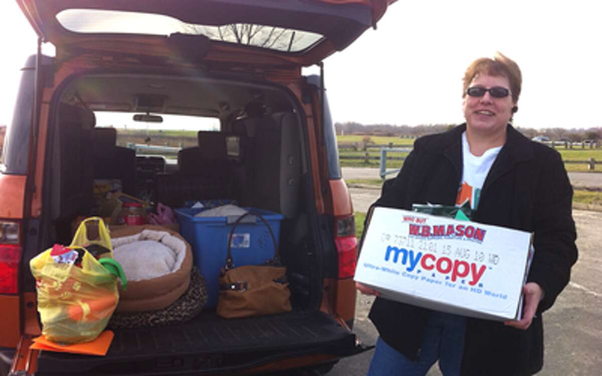Mandy Oram, of Paws and Kisses Pet Sitting Service in Shelton, making a Presents 4 Pets delivery to a local animal shelter.