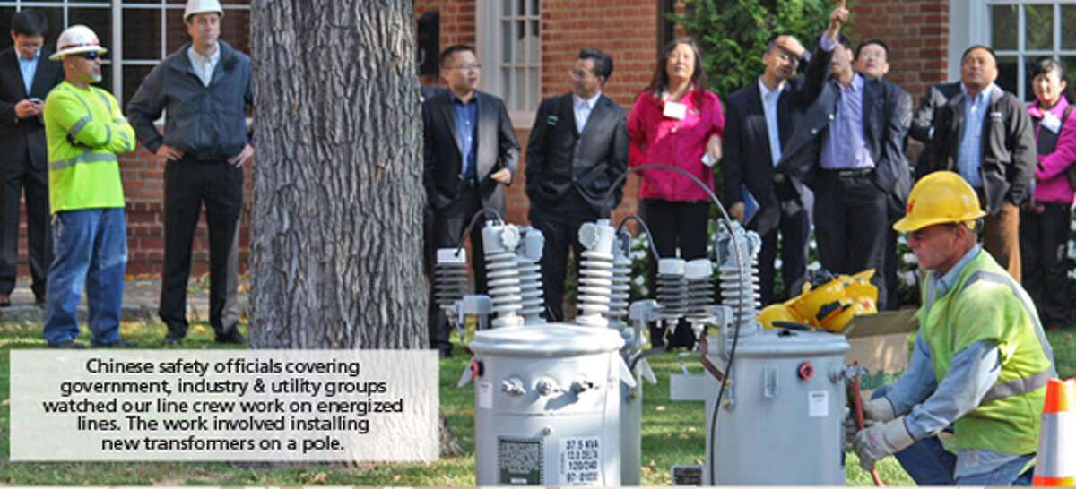 A United Illuminating crew demonstrates how they safely work on energized overhead wires.