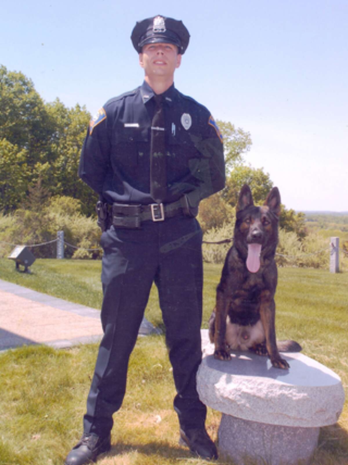 Shelton police officer Christopher Nugent, who is now a detective, with K-9 Jager, who has just retired from the force.